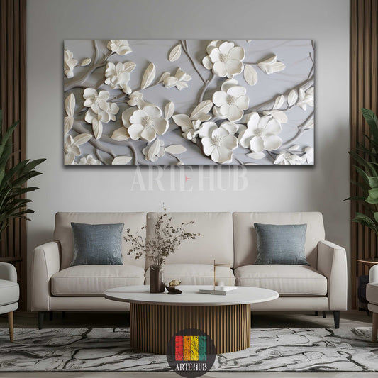 A large modern 3D white floral canvas wall art hanging above a cream sofa in a minimalist living room in Egypt. The artwork features raised white flower petals and leaves on a grey background, complementing the chic interior design.
تابلوه كانفاس كبير بتصميم زهور بيضاء ثلاثية الأبعاد مع أوراق الشجر على خلفية رمادية، معلق فوق كنبة كريمي في غرفة معيشة عصرية وأنيقة في مصر. يعكس العمل الفني ديكور منزلي راقٍ.