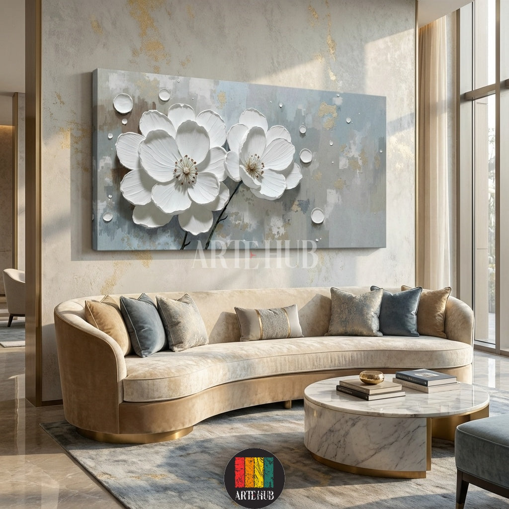 Detailed view of a large rectangular 3D canvas wall art featuring two prominent white flowers with textured petals and water droplets, set against a grey and gold abstract background, displayed above a curved beige sofa in a luxurious living room in Egypt.
تابلوه جداري كبير مستطيل بتصميم زهور بيضاء ثلاثية الأبعاد مع قطرات ماء وخلفية تجريدية رمادية وذهبية، معروض فوق كنبة منحنية بيج في غرفة معيشة فاخرة في مصر.