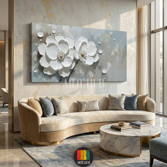 Detailed view of a large rectangular 3D canvas wall art featuring two prominent white flowers with textured petals and water droplets, set against a grey and gold abstract background, displayed above a curved beige sofa in a luxurious living room in Egypt.
تابلوه جداري كبير مستطيل بتصميم زهور بيضاء ثلاثية الأبعاد مع قطرات ماء وخلفية تجريدية رمادية وذهبية، معروض فوق كنبة منحنية بيج في غرفة معيشة فاخرة في مصر.