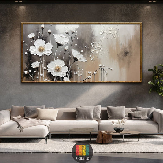 Large framed 3D textured white floral canvas wall art with abstract grey and beige background, hanging above a contemporary grey sofa in an Egyptian living room. Ideal for modern home decor in Egypt.
لوحة فنية كبيرة مؤطرة من الكانفاس بتصميم زهور بيضاء بارزة ثلاثية الأبعاد على خلفية تجريدية رمادية وبيج، معلقة فوق أريكة رمادية عصرية في غرفة معيشة مصرية. مثالية لديكور المنزل العصري في مصر.