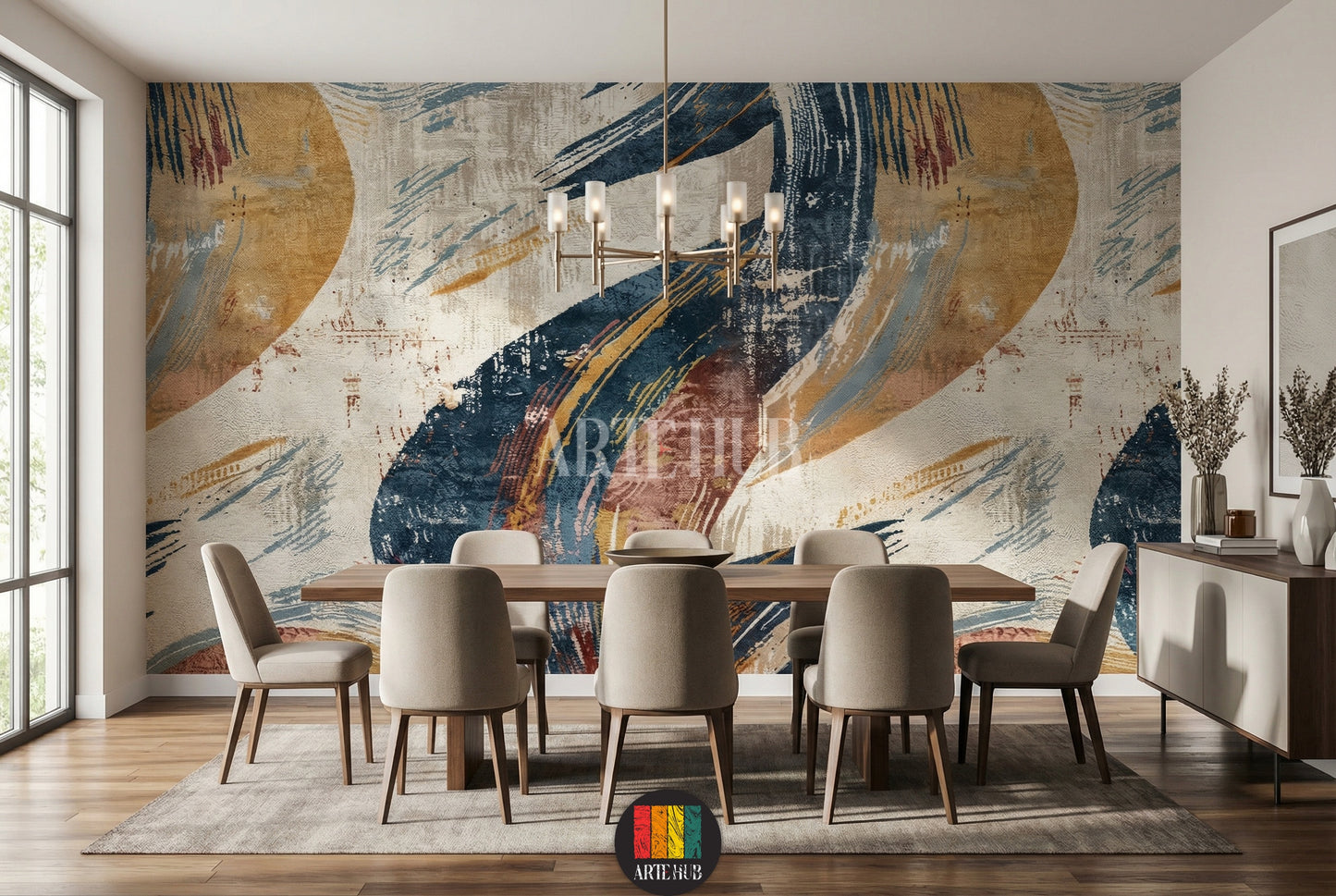 A modern dining room featuring a striking abstract wallpaper with bold blue, yellow, and beige brushstrokes. The room includes a wooden dining table, beige upholstered chairs, and a contemporary chandelier, enhancing stylish home decor in Egypt.
غرفة طعام عصرية مع ورق حائط تجريدي مميز بضربات فرشاة جريئة باللون الأزرق والأصفر والبيج. تشمل الغرفة طاولة طعام خشبية وكراسي منجدة بيج وثريا حديثة، مما يعزز الديكور المنزلي الأنيق في مصر.
room: dining room