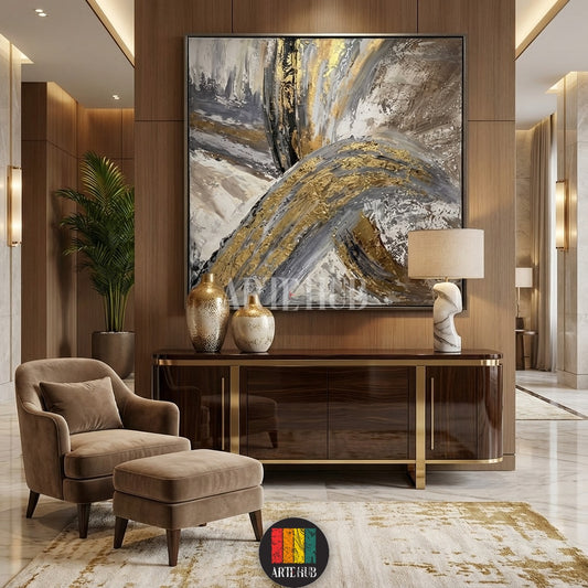 Large abstract canvas painting with gold, grey, white, and black brushstrokes, displayed in a modern living room in Egypt. Features textured art ideal for luxury home decor in Egyptian apartments.
تابلوه كانفاس تجريدي كبير بألوان ذهبية ورمادية وبيضاء وسوداء، معروض في غرفة معيشة عصرية وفاخرة في مصر. عمل فني محكم مثالي للديكورات المنزلية الفاخرة في الشقق المصرية.