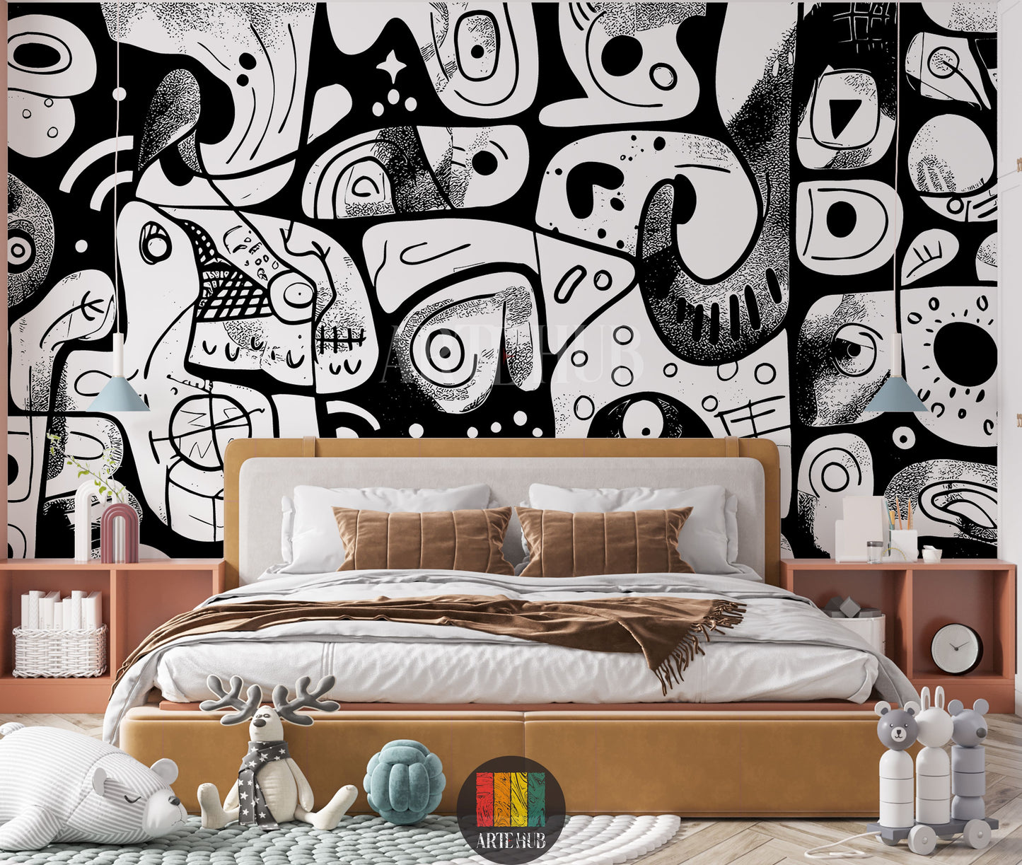 A modern bedroom featuring a bold black and white abstract doodle wallpaper covering the entire back wall. A large bed with a light brown upholstered headboard and base, white sheets, and brown pillows is centered. On either side are light brown nightstands with decorative items like blue lamps, vases, and books. The room includes a patterned rug, a striped bear plush toy, a reindeer toy, and a blue knot cushion, suggesting a creative and playful space.
غرفة نوم عصرية تتميز بورق حائط جريء بتصميم تجريدي أبيض