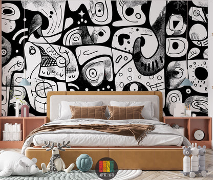 A modern bedroom featuring a bold black and white abstract doodle wallpaper covering the entire back wall. A large bed with a light brown upholstered headboard and base, white sheets, and brown pillows is centered. On either side are light brown nightstands with decorative items like blue lamps, vases, and books. The room includes a patterned rug, a striped bear plush toy, a reindeer toy, and a blue knot cushion, suggesting a creative and playful space.
غرفة نوم عصرية تتميز بورق حائط جريء بتصميم تجريدي أبيض