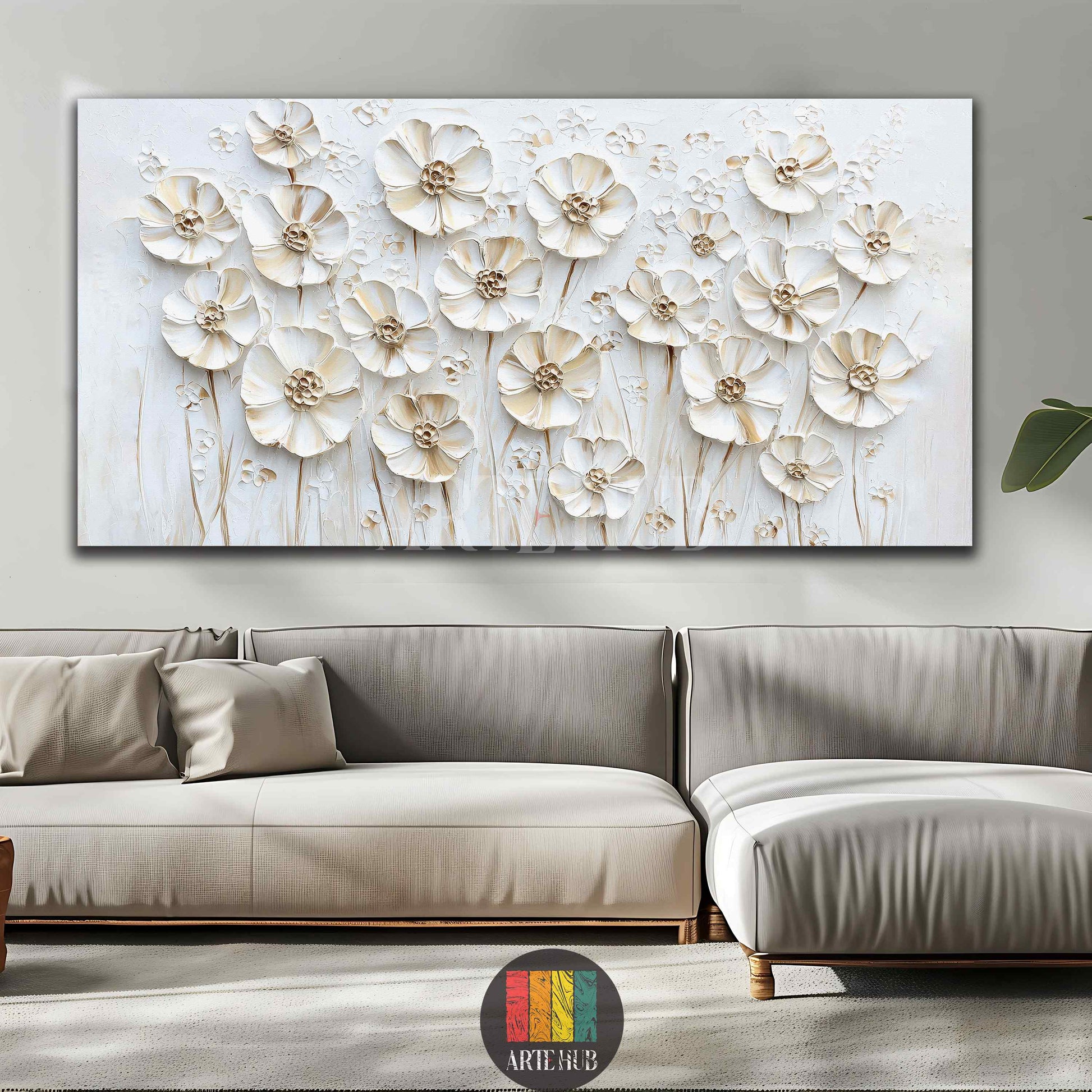 Large white 3D floral canvas wall art with textured petals, displayed above a wooden sideboard in a modern, elegant dining room in Egypt. Features a long oval dining table, beige chairs, and a crystal chandelier, creating a luxurious Egyptian home interior.
تابلوه كبير من القماش بنقوش ورد ثلاثية الأبعاد باللون الأبيض، معروض فوق بوفيه خشبي في غرفة طعام عصرية وأنيقة في مصر. يظهر في الصورة طاولة طعام بيضاوية طويلة وكراسي باللون البيج وثريا كريستالية، مما يخلق تصميماً داخلياً فاخراً للمنزل في مصر.