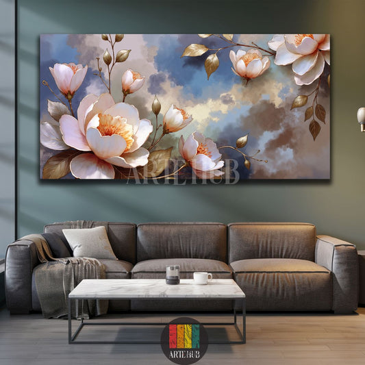 A large horizontal canvas print featuring elegant white and pink blossom flowers with golden leaves against a cloudy blue and beige abstract background, displayed above a wooden console table in a modern Egyptian living room setting.
تابلوه كانفاس أفقي كبير يصور زهور بيضاء ووردية أنيقة مع أوراق ذهبية على خلفية سماء زرقاء وبيج غائمة، معروض فوق طاولة كونسول خشبية في غرفة معيشة عصرية في مصر.