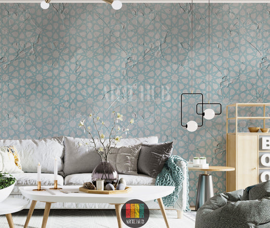 Full view of a modern living room featuring a light blue and grey geometric textured wallpaper with an Islamic pattern. A white sofa with grey pillows, a white coffee table with candles and decor, and modern black pendant lights are visible. Ideal for contemporary home decor in Egypt.
صورة كاملة لغرفة معيشة عصرية بها ورق حائط مزخرف بنقوش هندسية إسلامية باللون الأزرق الفاتح والرمادي. تظهر كنبة بيضاء بوسائد رمادية، طاولة قهوة بيضاء مع شموع وديكور، وإضاءة معلقة حديثة. 
room: living room
