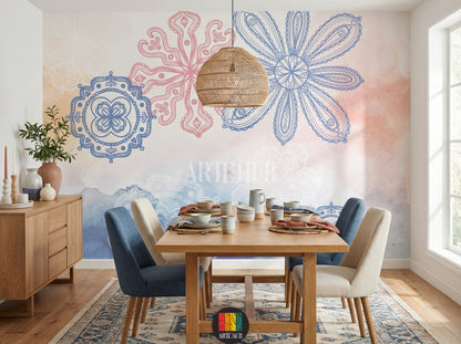 A cozy dining room features a large decorative wallpaper with blue and pink mandala-style floral patterns and watercolor washes. A wooden dining table is set with ceramics, surrounded by blue and beige chairs. A woven pendant light hangs above. Ideal for contemporary home decor in Egypt.
غرفة طعام دافئة مع ورق حائط مزخرف بنقوش ماندالا زهرية باللونين الأزرق والوردي، وخلفية مائية. طاولة طعام خشبية مجهزة بأطباق خزفية وكراسي باللونين الأزرق والبيج. إضاءة معلقة من الخيزران. 
room: dining room