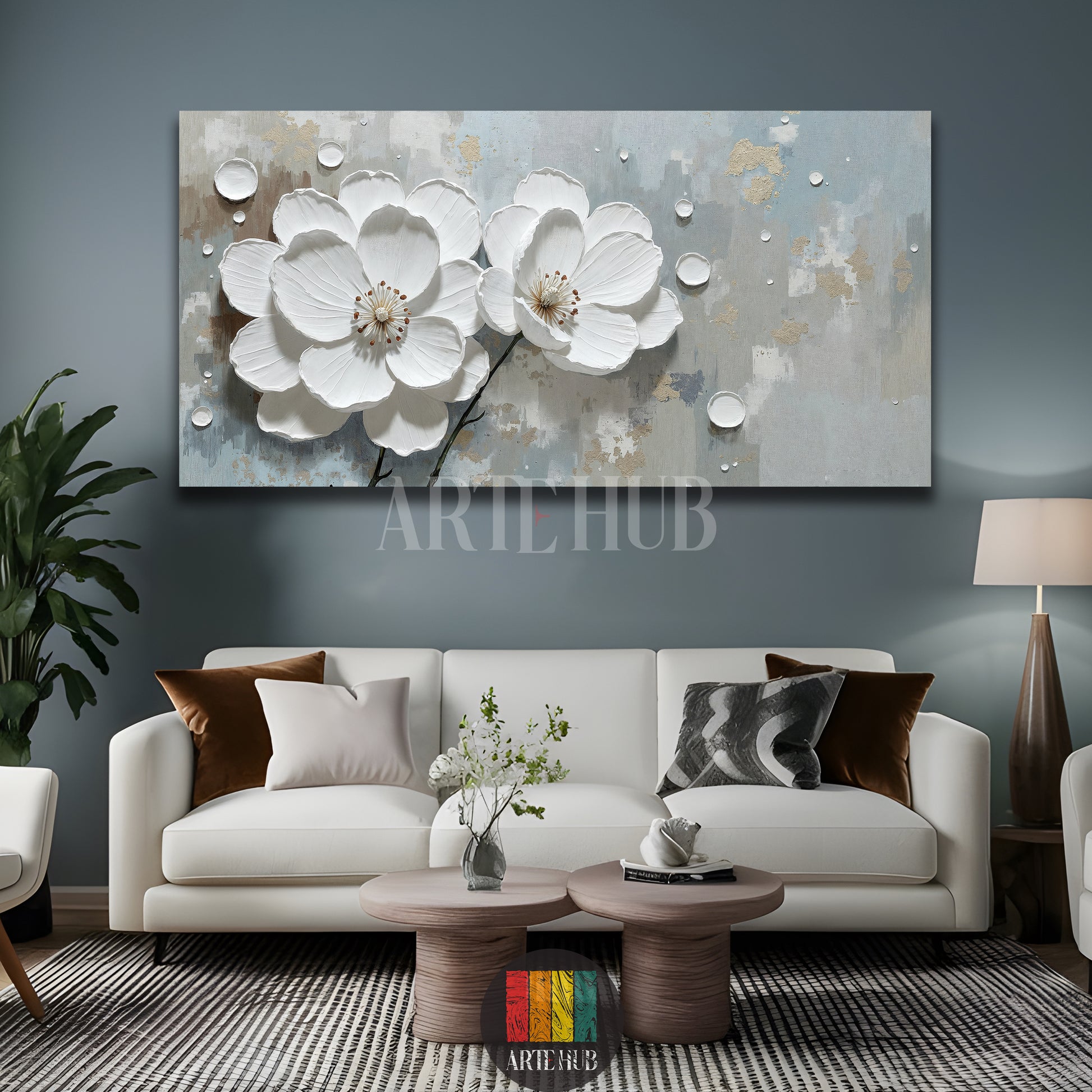 A large rectangular canvas wall art by Artehub featuring two 3D textured white blossoms on a minimalist grey and gold background, styled for an elegant living room in Egypt.

لوحة كانفاس كبيرة من Artehub تضم زهوراً بيضاء بارزة بتصميم ثلاثي الأبعاد على خلفية رمادية وذهبية، مناسبة لديكورات المنازل الفاخرة في مصر.