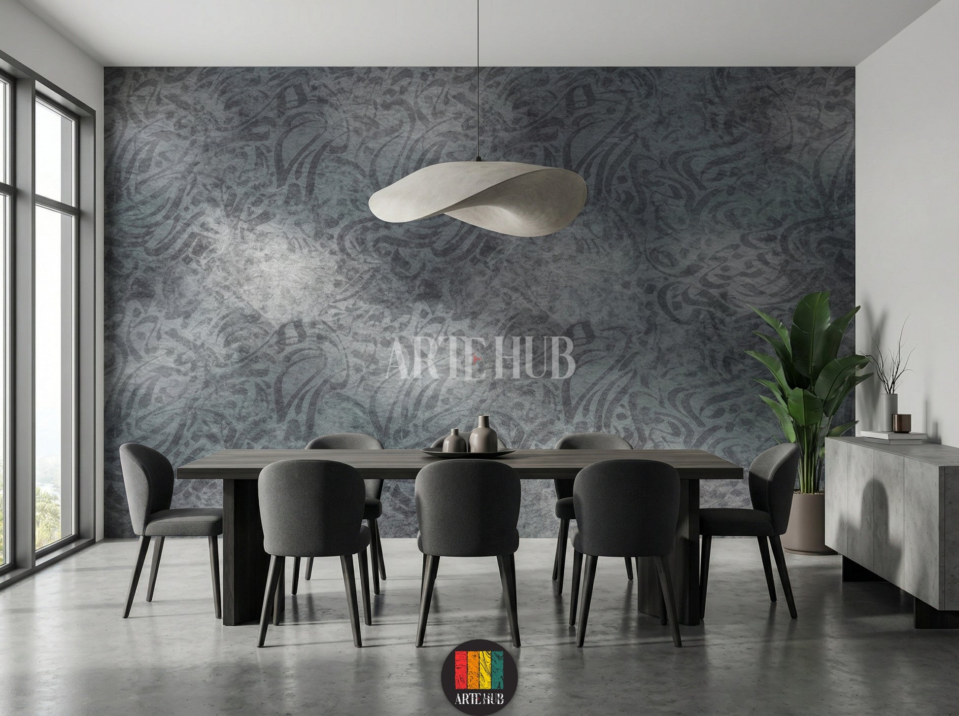 Detailed view of a modern dining room featuring a dark grey abstract patterned wallpaper. The room includes a large dark wood dining table, grey upholstered chairs, a unique white pendant light, and a tall green plant, enhancing the contemporary Egyptian decor.
صورة مفصلة لغرفة طعام عصرية تعرض ورق حائط رمادي داكن بنقوش تجريدية. الغرفة تحتوي على طاولة طعام خشبية داكنة كبيرة، كراسي قماش رمادية، إضاءة معلقة بيضاء فريدة، ونبات أخضر طويل، مما يبرز الديكور العصري في مصر.
room: dining room