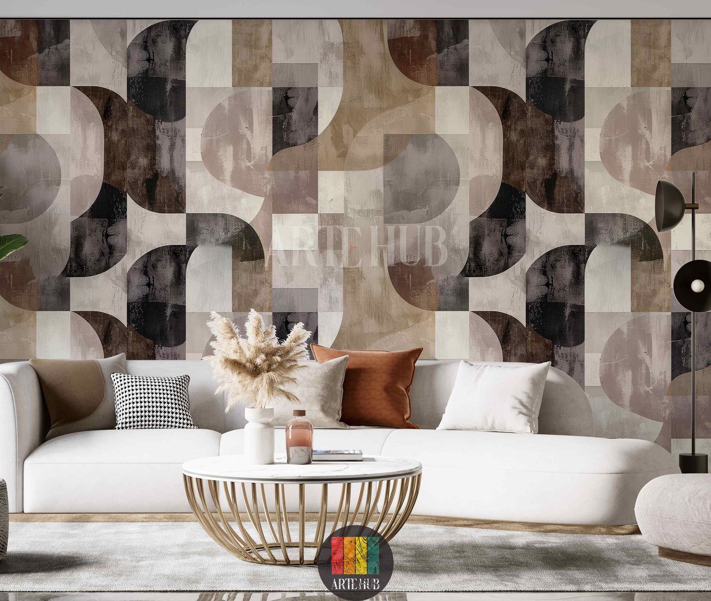 A living room featuring a modern geometric abstract wallpaper with interlocking arcs and squares in earthy tones of brown, beige, grey, and black, enhancing contemporary interior decor in Egypt. A white sofa, gold coffee table, and pampas grass complete the stylish setting.
غرفة معيشة حديثة تتميز بورق حائط بتصميم هندسي تجريدي بأقواس ومربعات متداخلة بألوان ترابية من البني والبيج والرمادي والأسود، 
مما يعزز الديكور الداخلي المعاصر في مصر. 
room: living room