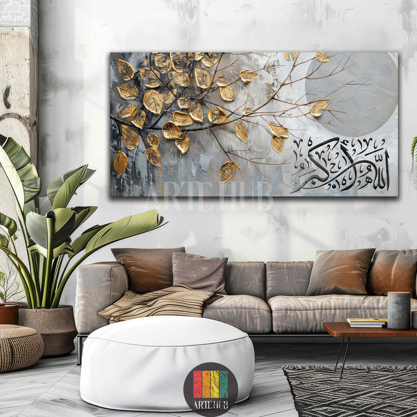Large canvas art featuring shimmering golden leaves on tree branches, set against a grey abstract background with elegant black Arabic calligraphy. The artwork is centered above a luxurious dark green velvet bed with a tufted headboard in a modern, light-filled Egyptian bedroom. Wooden slatted wall panels and marble flooring are visible, creating a sophisticated and inspiring ambiance.
تابلوه فني كبير يصور أوراقًا ذهبية متلألئة على فروع شجرة مع خلفية رمادية مجردة وخط عربي أسود أنيق. اللوحة معلقة فوق سرير فا