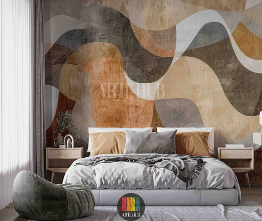 Full view of a modern bedroom featuring an abstract wavy pattern wallpaper in earthy tones of brown, beige, and grey. A neutral-colored L-shaped sofa with throw blankets and pillows sits against the wall. A dark wood coffee table with decor items, a TV unit, a floor lamp, and two brown leather armchairs are also visible, showcasing contemporary home decor in Egypt.
منظر كامل لغرفة معيشة عصرية تضم ورق حائط بتصميم أمواج تجريدية بألوان ترابية من البني والبيج والرمادي.  L بلون محايد 
room: bedroom