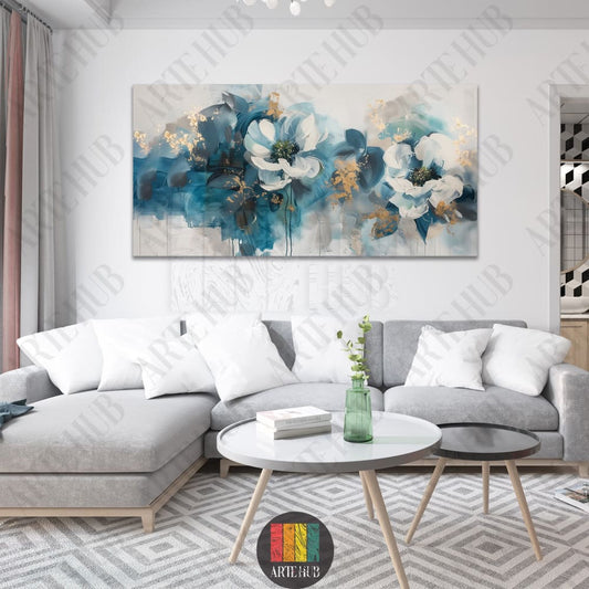 A large horizontal canvas wall art featuring two abstract white flowers with teal and gold leaf detailing above a light grey sofa.