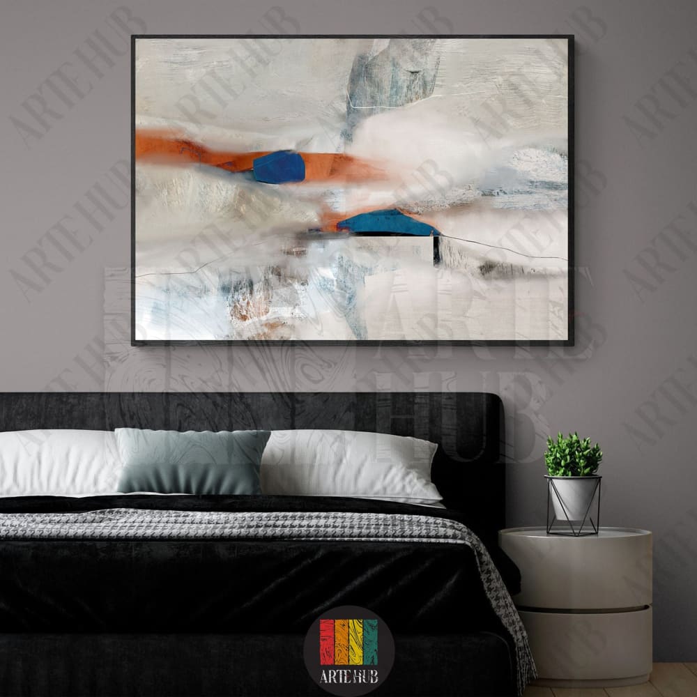 A modern abstract canvas wall art featuring textured strokes of white, terracotta, and deep blue, framed in black and styled above a luxury bedroom bed.