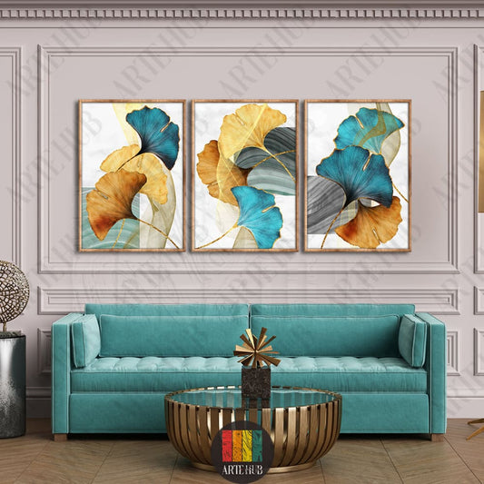 Triptych canvas wall art featuring teal and gold ginkgo leaves in a luxury modern living room setting in Egypt.