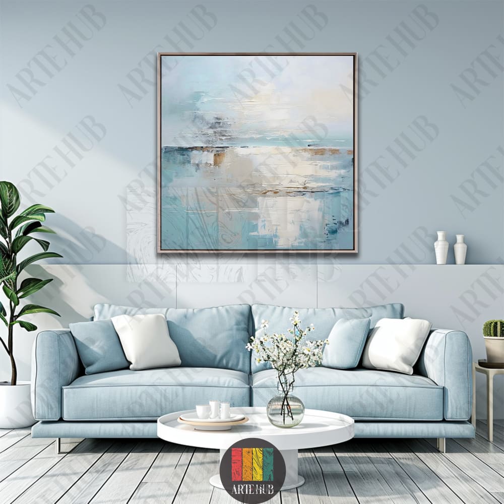 A serene abstract canvas wall art painting with soft blue and cream tones, framed above a modern blue sofa in a luxury Egyptian home.
