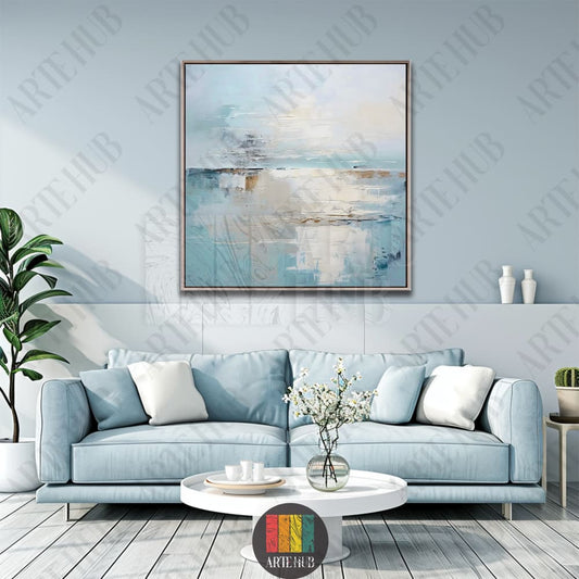A serene abstract canvas wall art painting with soft blue and cream tones, framed above a modern blue sofa in a luxury Egyptian home.