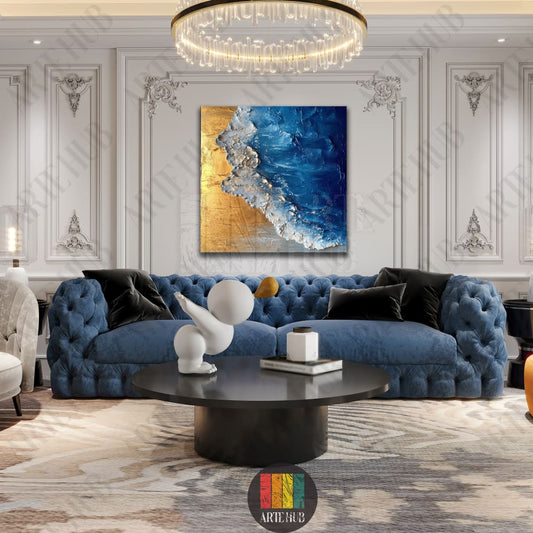 Abstract ocean canvas wall art with textured blue waves and gold sand detailing hanging in a luxury Egyptian living room.