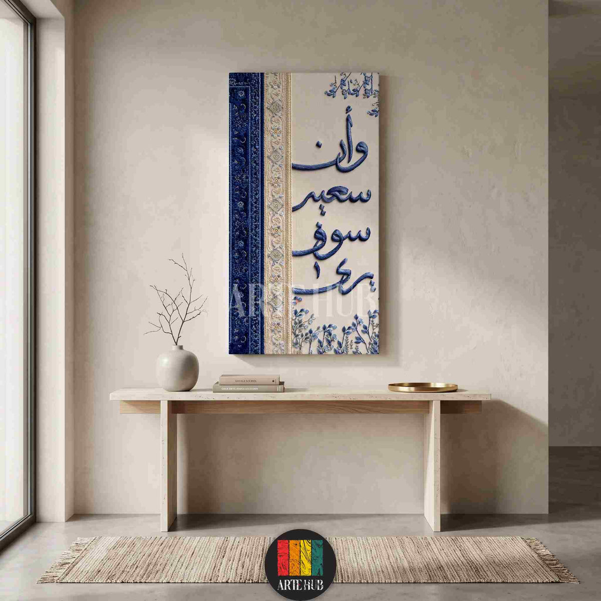 A vertical canvas wall art featuring elegant blue Arabic calligraphy on a cream textured background with floral details, styled in a luxury modern room.