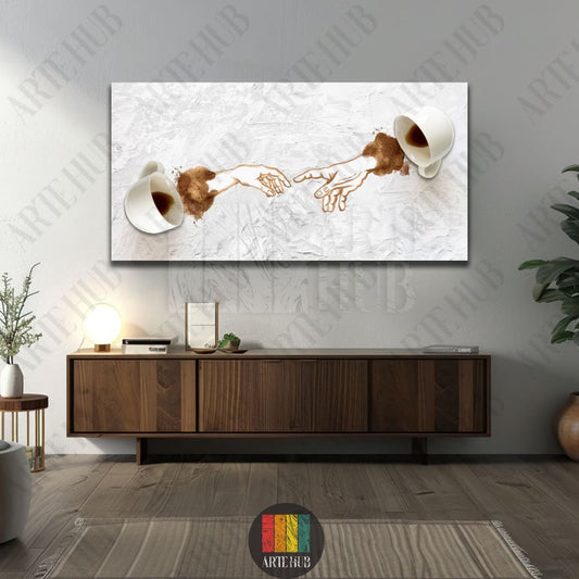 Modern canvas wall art featuring coffee spills forming the iconic Creation of Adam hands between two white cups on a white textured background.