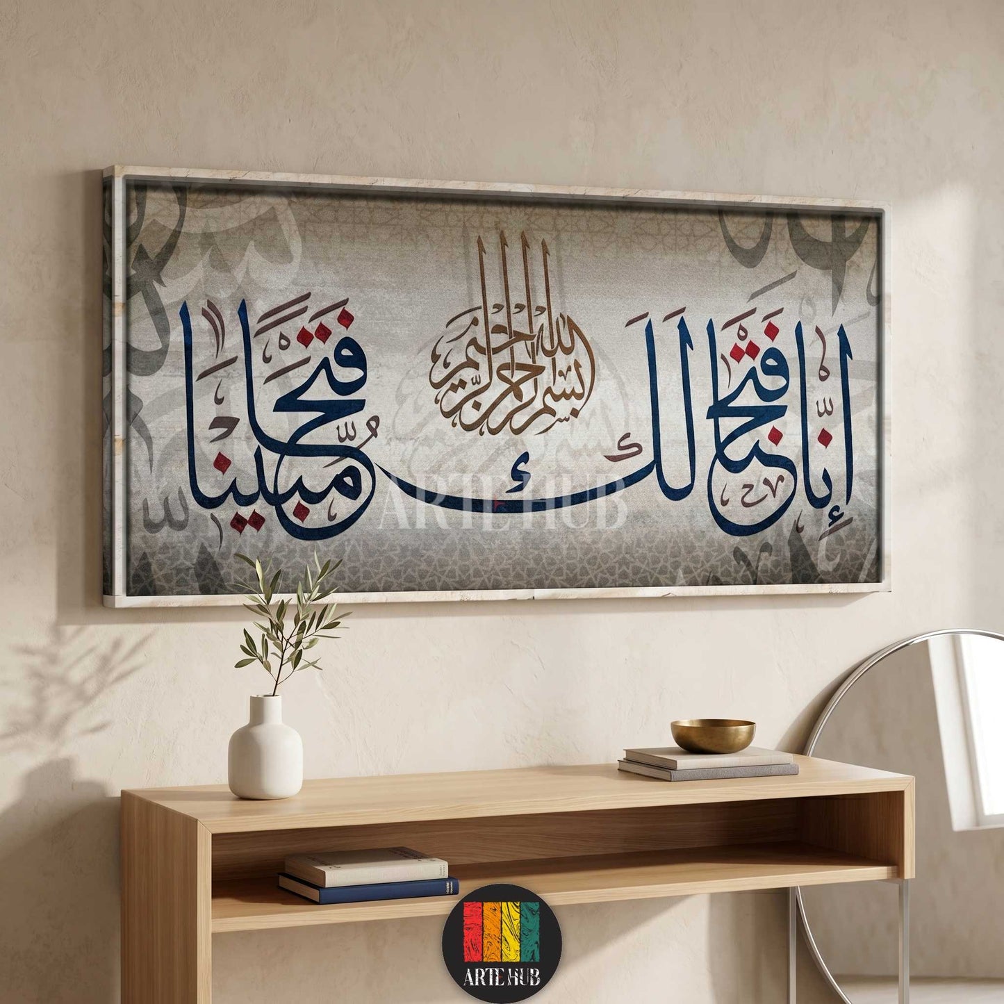 A horizontal luxury canvas wall art piece featuring modern Arabic calligraphy in blue and red tones over a textured grey background in a minimalist room.