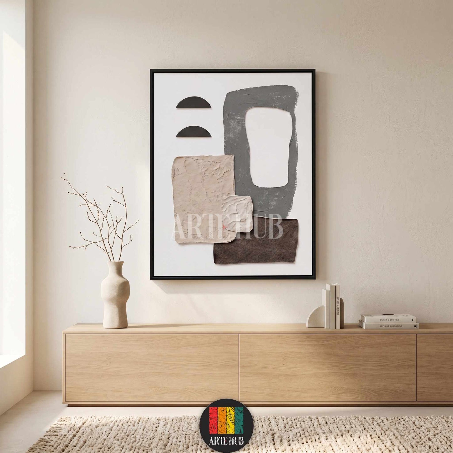 A minimalist abstract canvas wall art piece with textured earth tones and geometric shapes in a black frame, styled in a modern living room in Egypt.