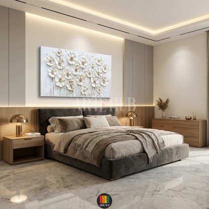 A large horizontal canvas wall art featuring 3D textured white and gold flowers hung above a bed in a luxury modern bedroom in Egypt.
