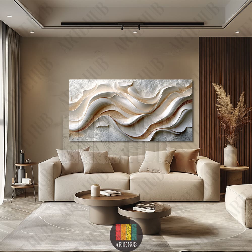 A large horizontal canvas wall art with 3d textured white and gold abstract waves hung above a beige sofa in a modern Egyptian home.