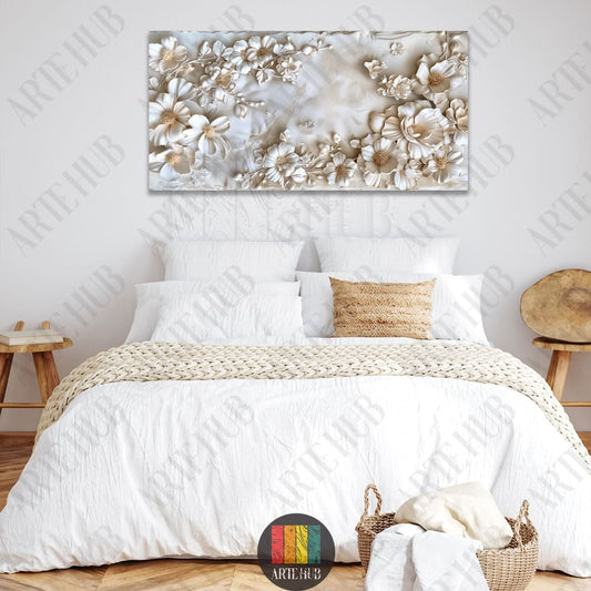A large horizontal canvas wall art featuring 3D-effect relief white flowers, displayed above a cozy white bed in a modern Egyptian interior.
