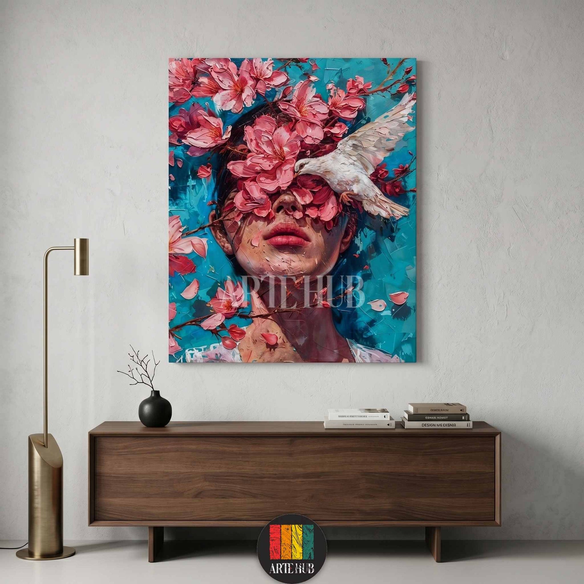 A surreal canvas wall art piece depicting a woman's face adorned with vibrant pink cherry blossoms and a white dove against a textured teal background.