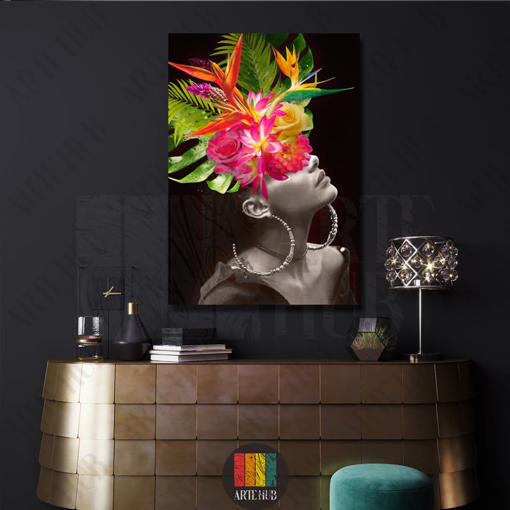 A sophisticated canvas wall art piece featuring a black and white female portrait with a vibrant, colorful tropical flower crown in a luxury modern setting.