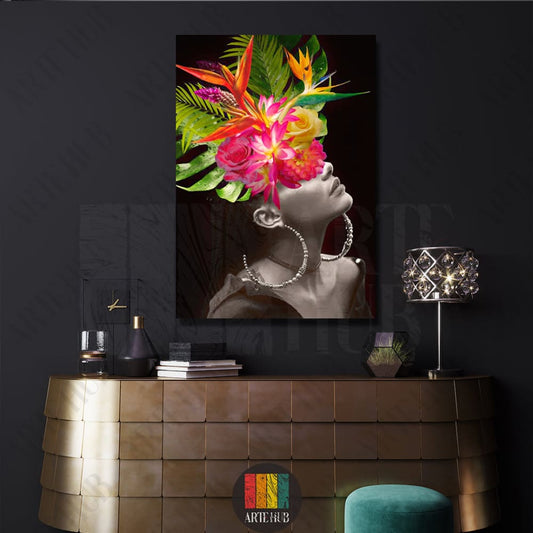 A sophisticated canvas wall art piece featuring a black and white female portrait with a vibrant, colorful tropical flower crown in a luxury modern setting.