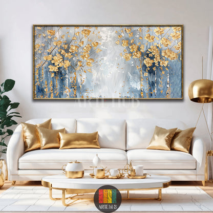 Luxurious landscape canvas wall art featuring abstract golden trees on a textured blue and white background with a premium gold frame in a modern setting.