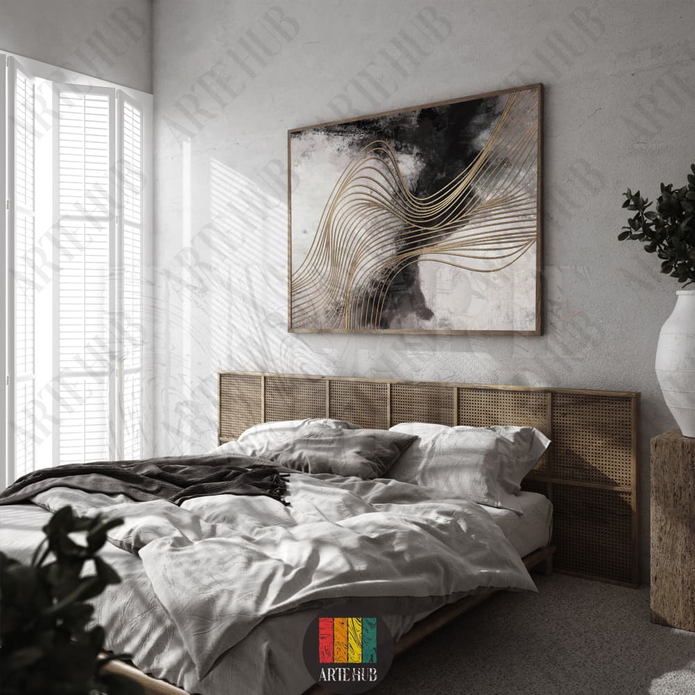 Abstract canvas wall art featuring black and white ink washes with flowing gold metallic lines in a modern bedroom setting.