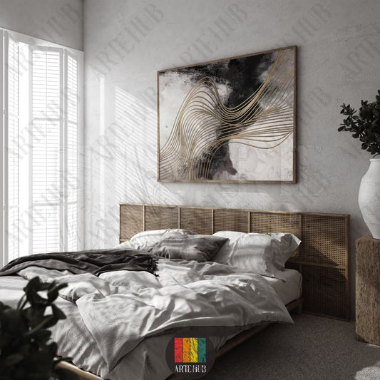 Abstract canvas wall art featuring black and white ink washes with flowing gold metallic lines in a modern bedroom setting.