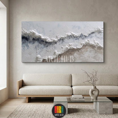 A large horizontal textured abstract canvas wall art piece with 3D white and grey impasto waves hung in a minimalist living room in Egypt.
