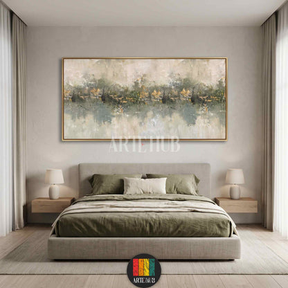 Large horizontal abstract landscape canvas painting with gold leaf accents and sage green textures, framed in gold, hanging above a contemporary bed.