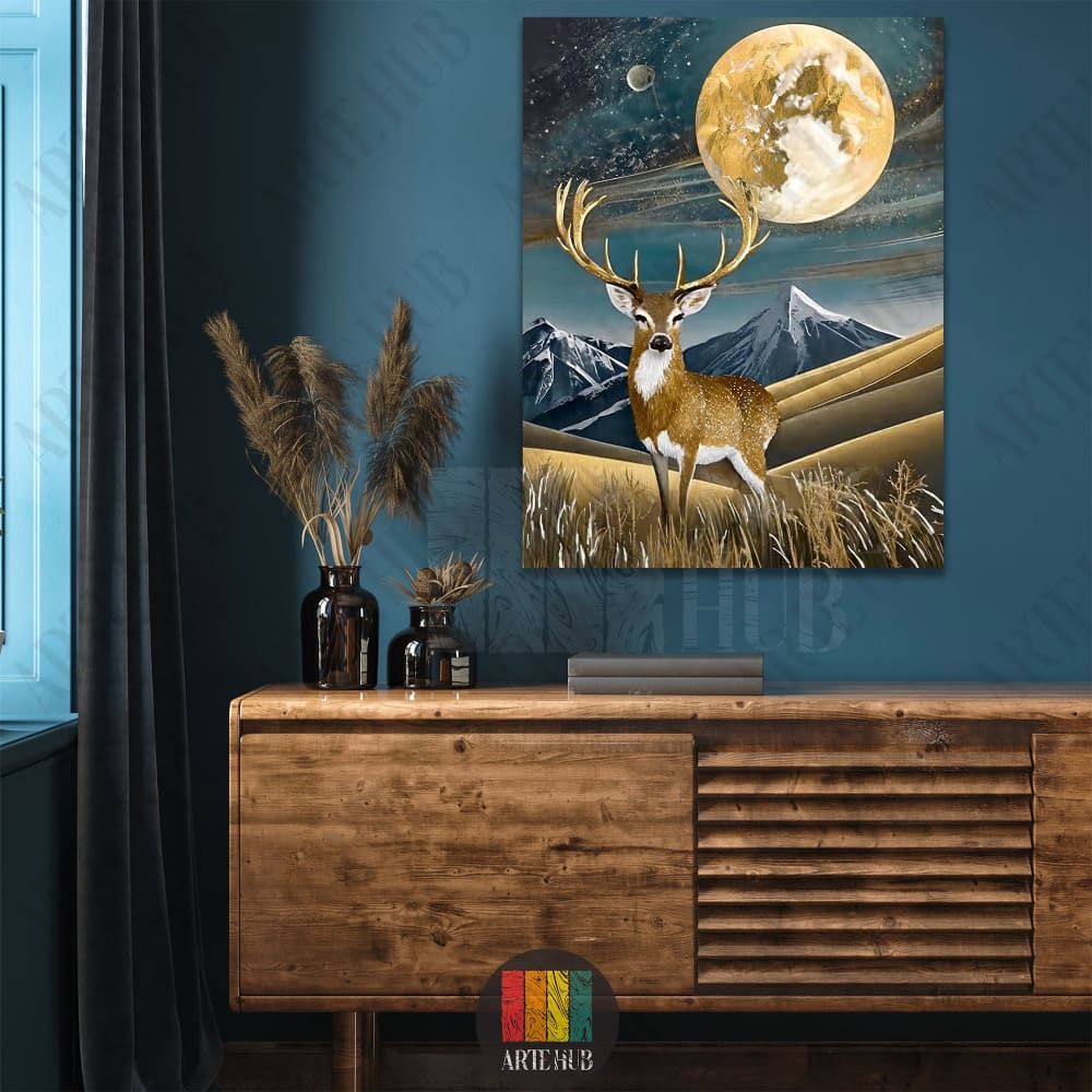 A majestic golden deer standing in a golden field with snowy mountains and a large moon in the background, luxury canvas wall art for modern home decor.