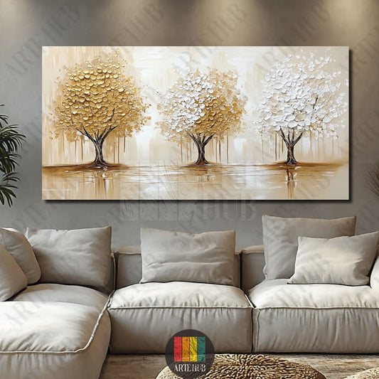 Golden Grove A wide horizontal canvas wall art featuring three abstract trees with thick, textured gold and white leaves on a beige background, styled in a modern living room in Egypt.