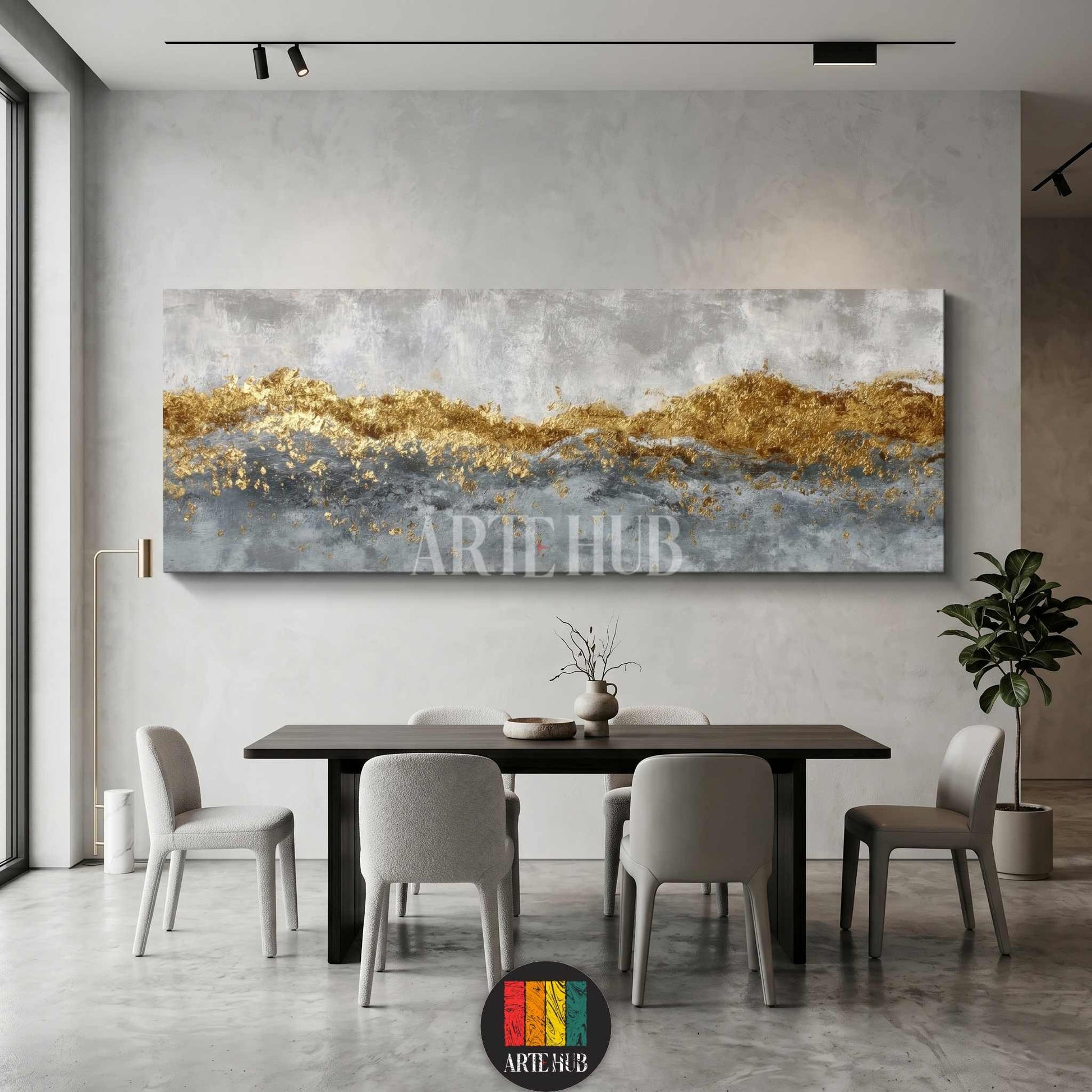 A luxurious panoramic abstract canvas wall art featuring metallic gold leaf textures and grey brushstrokes, styled in a modern minimalist dining room.