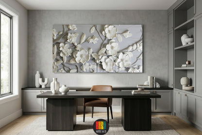 A premium 3D sculpted white magnolia floral canvas wall art hanging in a modern gray home office setting.