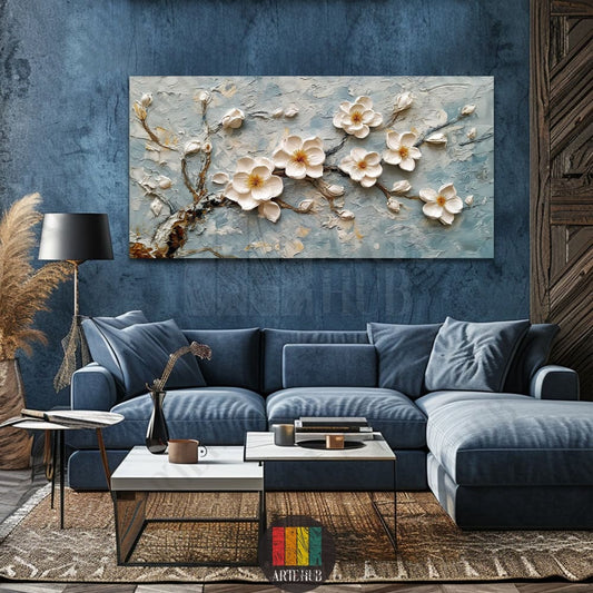 Impasto style textured 3D white magnolia blossoms on a branch wall art canvas hanging in a modern navy blue living room in Egypt.