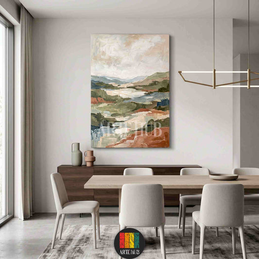 A vertical abstract landscape canvas wall art featuring rustic earth tones and expressive brushwork, styled in a minimalist dining room in Egypt.