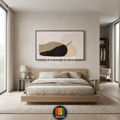 A large abstract canvas wall art piece featuring organic beige and black shapes hanging above a wooden bed in a minimalist luxury bedroom in Egypt.