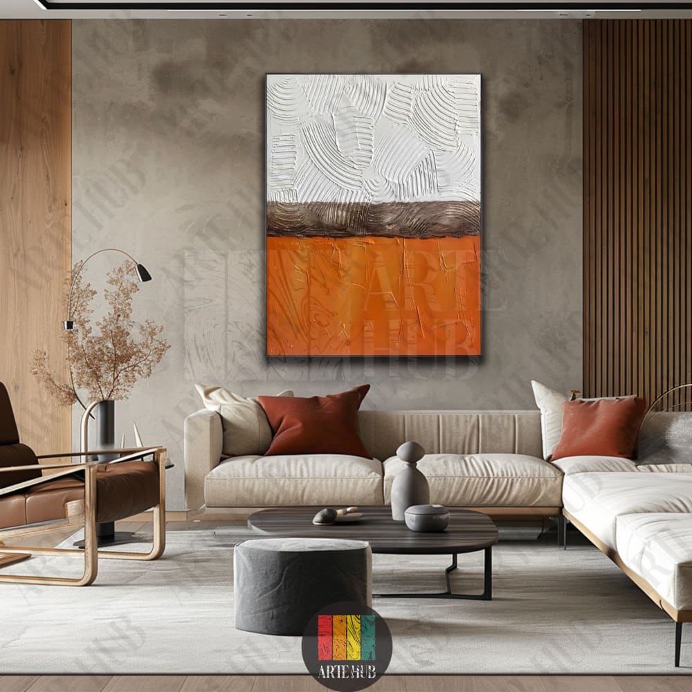 A premium textured abstract canvas wall art featuring heavy impasto strokes in white and burnt orange, displayed in a modern luxury living room in Egypt.