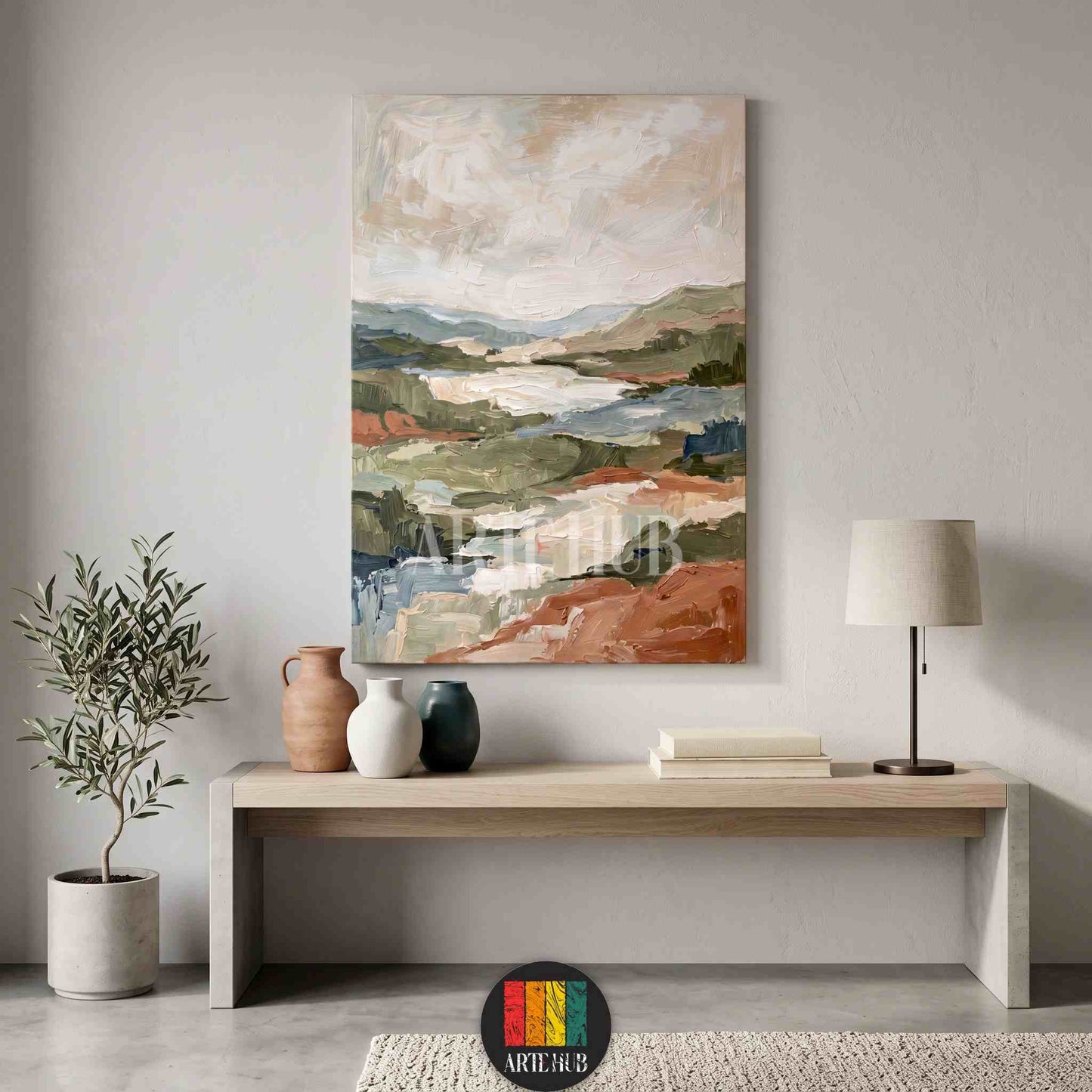 Abstract landscape canvas wall art featuring textured earthy tones of terracotta and sage green in a modern minimalist Egyptian living room.