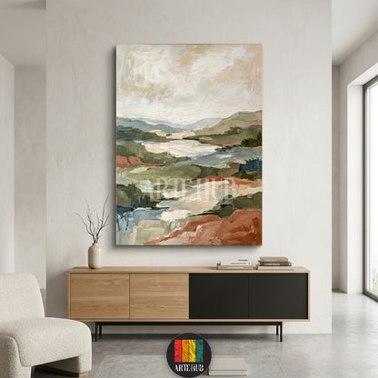 An abstract textured landscape canvas painting in earth tones like terracotta and green, displayed as modern wall decor in a high-end Egyptian home.
