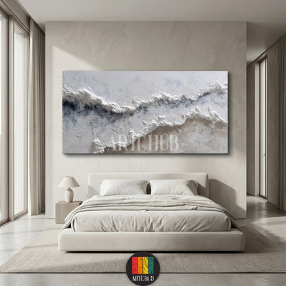 A large, textured 3D canvas wall art featuring white and blue abstract ocean waves hanging above a minimalist beige bed in a luxury Egyptian home.