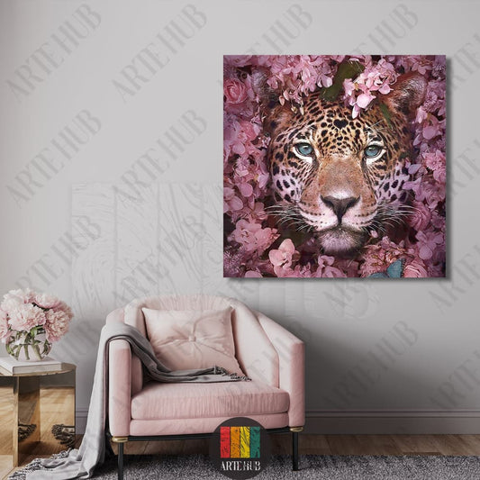 Artistic portrait of a leopard with blue eyes peeking through pink flowers, square canvas wall art hanging in a modern luxury living room in Egypt.